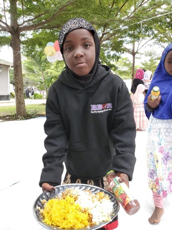 A child holding a plate of food